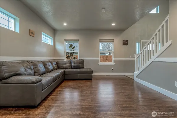 a living room with furniture and a hard wood floor