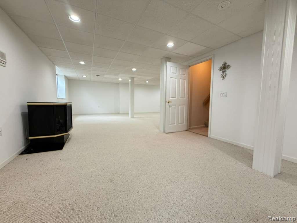 1154 Bluebird Drive Rochester, MI 48307 - Photo 28 of 34 Spacious lower-level room featuring light-toned carpeting, recessed lighting, and a suspended acoustic tile ceiling
