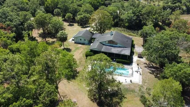 an aerial view of a house with a yard