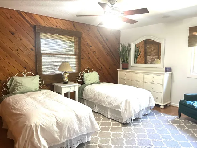 a bedroom with two beds and a chandelier