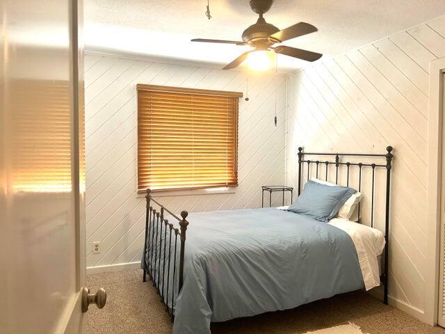 17534 103rd Terrace North Jupiter, FL 33478 - Photo 17 of 25 a bedroom with a bed and a chandelier