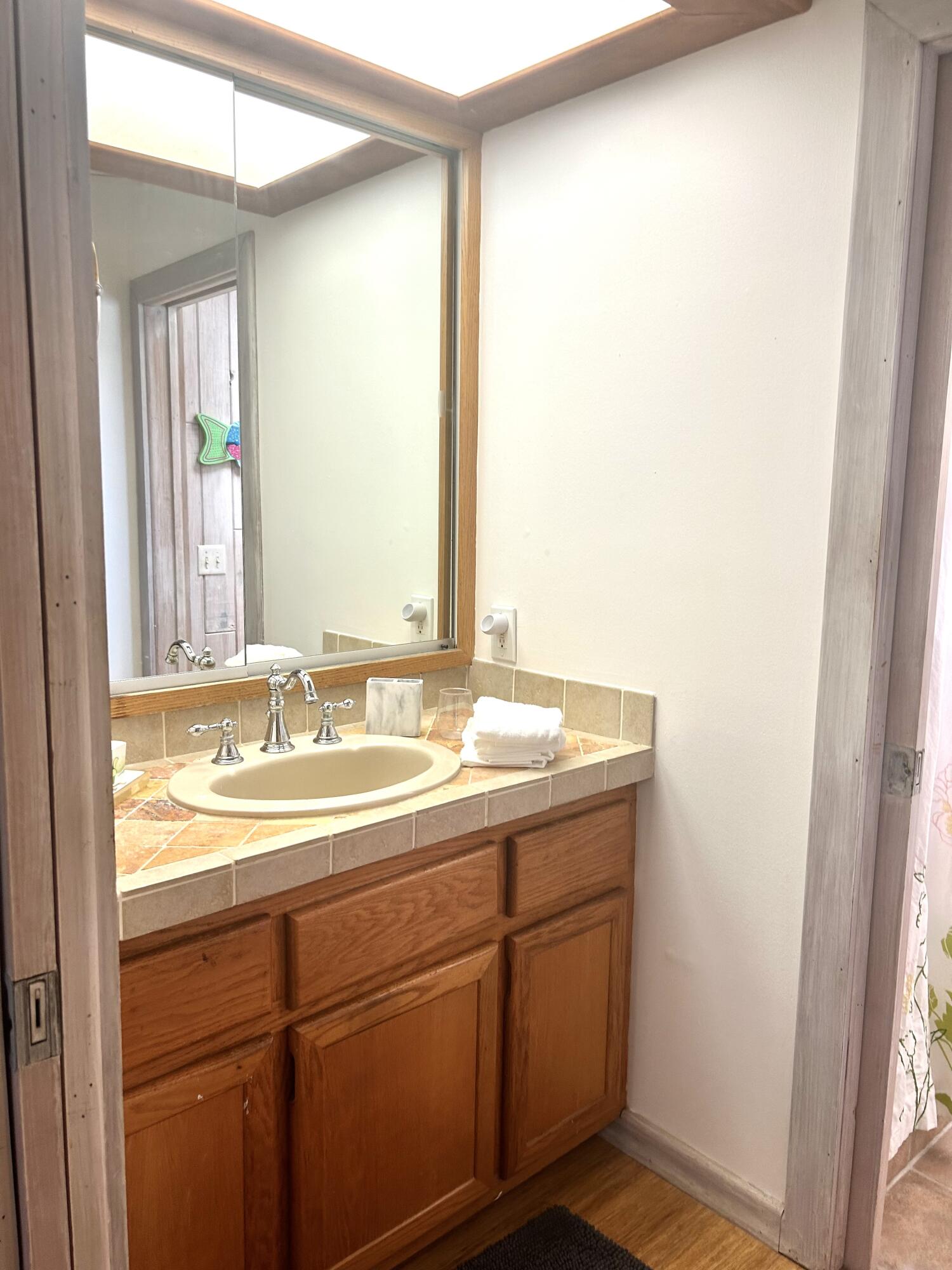 17534 103rd Terrace North Jupiter, FL 33478 - Photo 18 of 25 a bathroom with a sink and a mirror