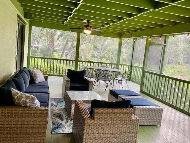 a roof deck with couches and wooden floor