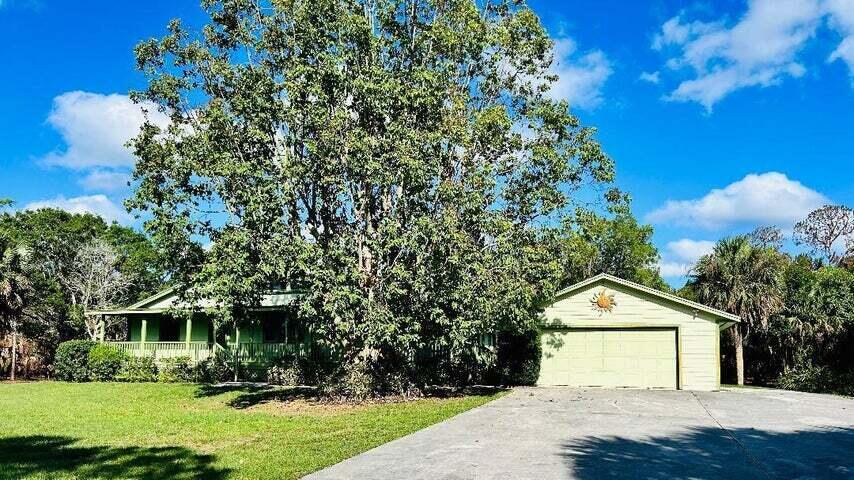 17534 103rd Terrace North Jupiter, FL 33478 - Photo 2 of 25 a front view of a house with garden