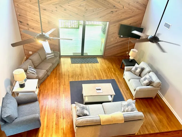 a living room with furniture and a painting on the wall