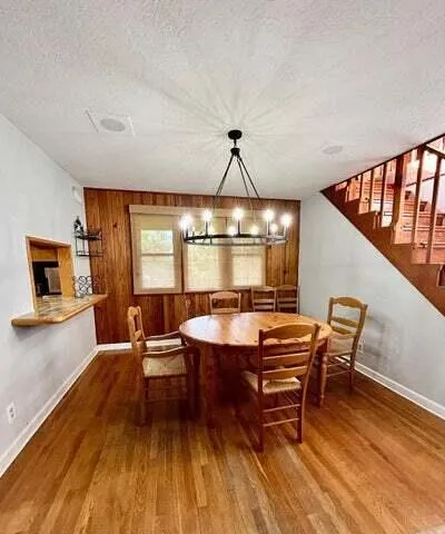 a dining room with furniture window and wooden floor