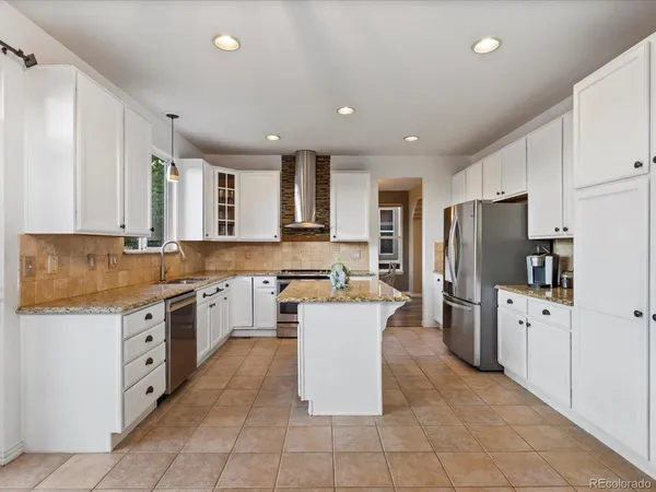 a kitchen with stainless steel appliances granite countertop a sink stove and window