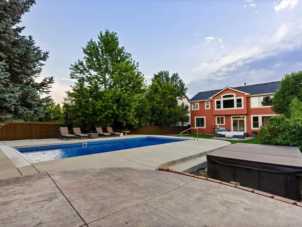a front view of house with yard and trees in the background