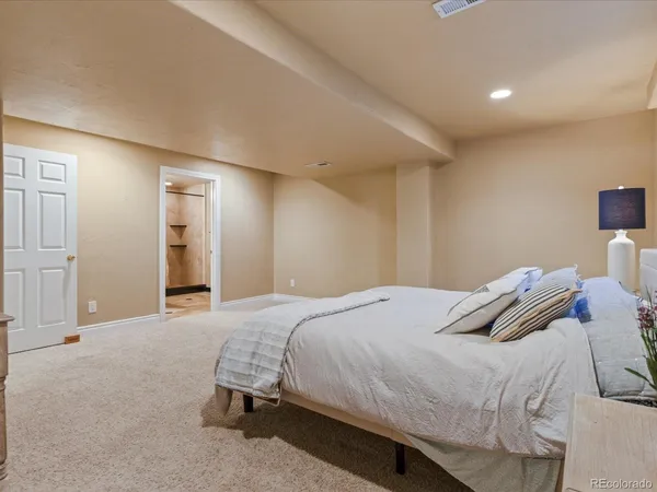 a bathroom with a granite countertop sink toilet and a mirror