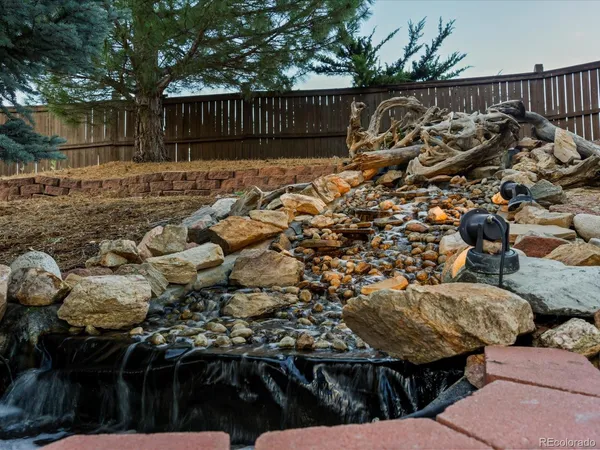 a view of a house with a backyard and sitting area
