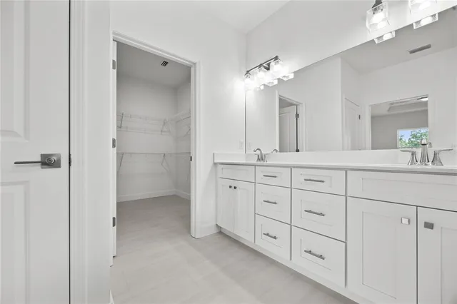 a bathroom with a double vanity sink and a mirror