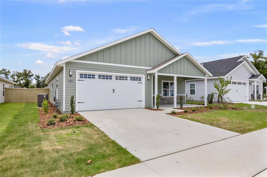 6702 Southwest 10th Lane Gainesville, FL 32607 - Photo 3 of 28 a front view of a house with a yard and garage