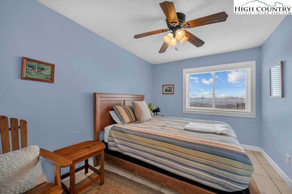 301 Pinnacle Inn Road, Unit 4314 Beech Mountain, NC 28604 - Photo 12 of 39 a bedroom with a bed and a large window