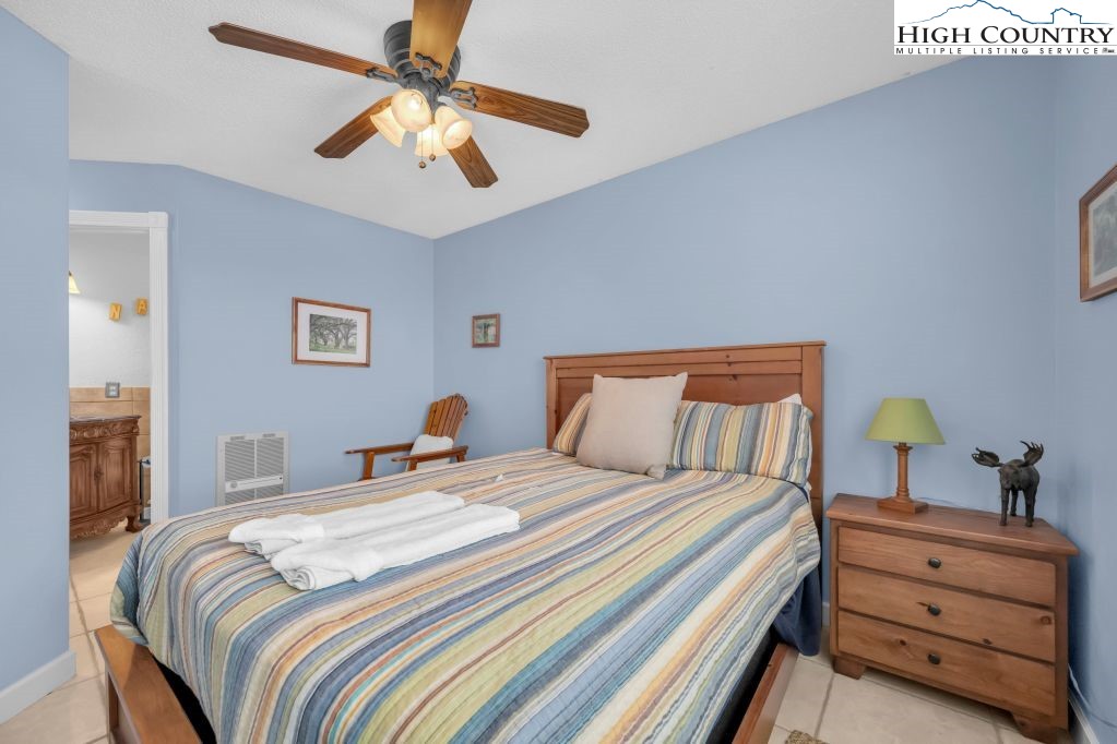 301 Pinnacle Inn Road, Unit 4314 Beech Mountain, NC 28604 - Photo 13 of 39 a bedroom with a bed and a chandelier