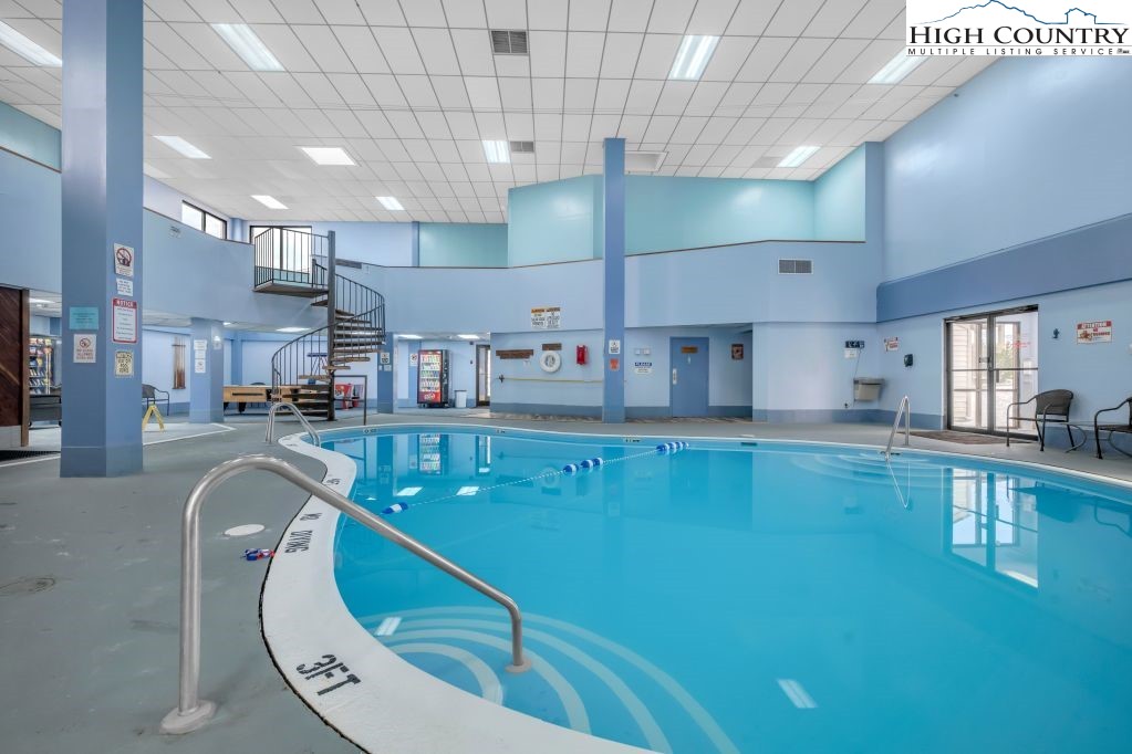 301 Pinnacle Inn Road, Unit 4314 Beech Mountain, NC 28604 - Photo 30 of 39 a room with stainless steel appliances lots of white furniture a chandelier