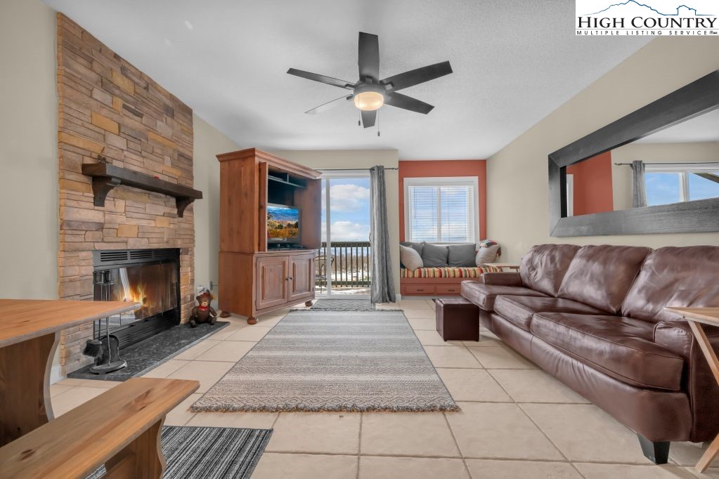 301 Pinnacle Inn Road, Unit 4314 Beech Mountain, NC 28604 - Photo 5 of 39 a living room with furniture and a fireplace
