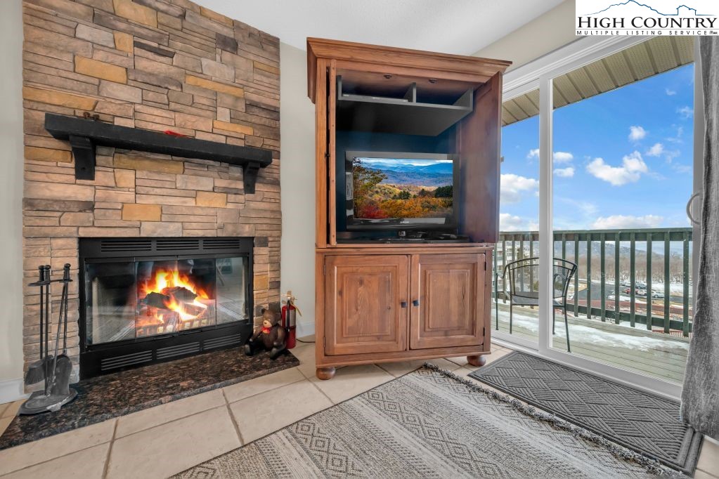301 Pinnacle Inn Road, Unit 4314 Beech Mountain, NC 28604 - Photo 6 of 39 a view of an empty room with a fireplace and wooden floor