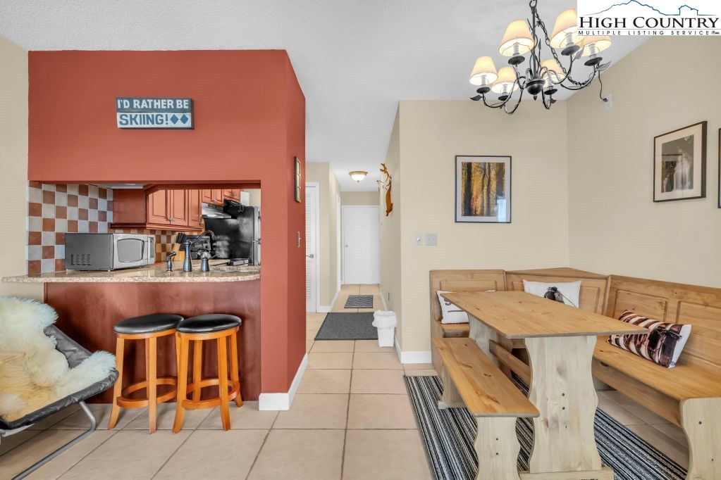 301 Pinnacle Inn Road, Unit 4314 Beech Mountain, NC 28604 - Photo 8 of 39 a living room with a dining table and chairs