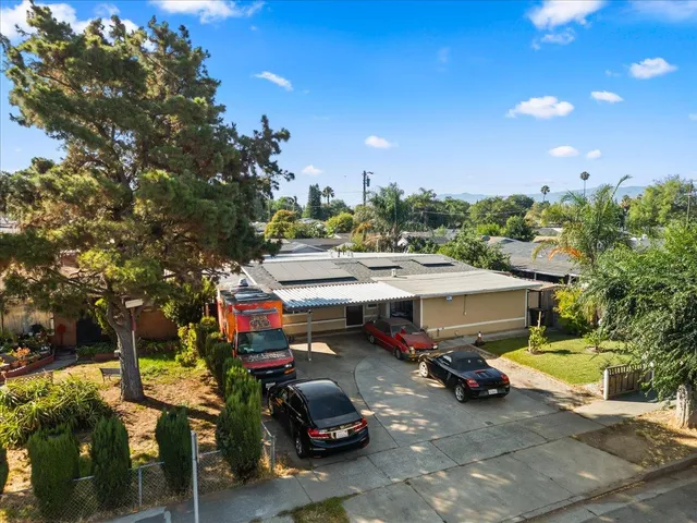 a view of a cars park in front of a building
