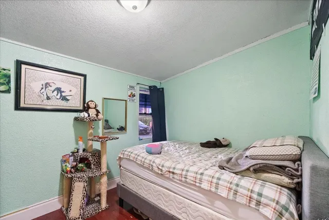 a living room with a couch and a dining table with wooden floor