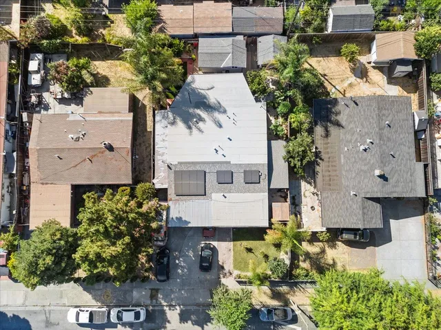 an aerial view of a house with a yard and garden