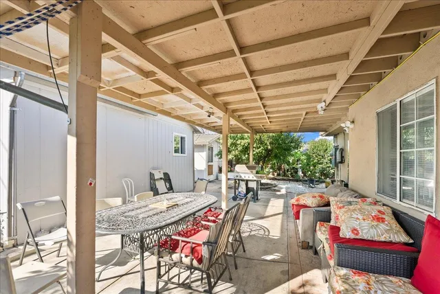 a view of a chair and tables in the patio