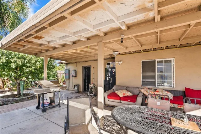 a view of a patio with table and chairs and potted plants