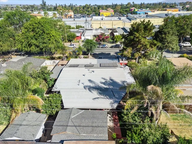 an aerial view of a house with a yard and lake view