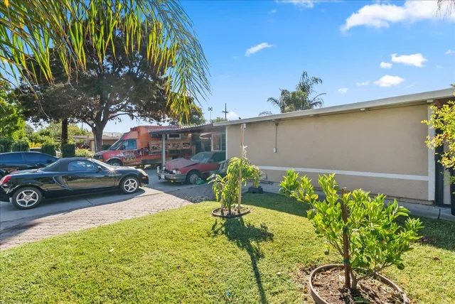 a view of a street with potted plants