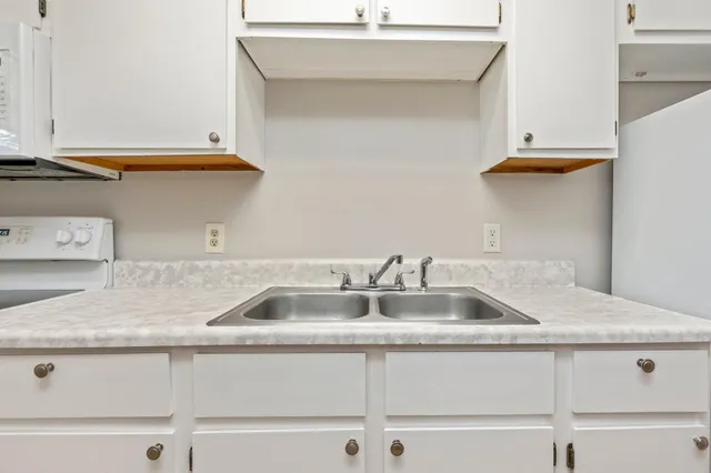 a kitchen with a sink and cabinets