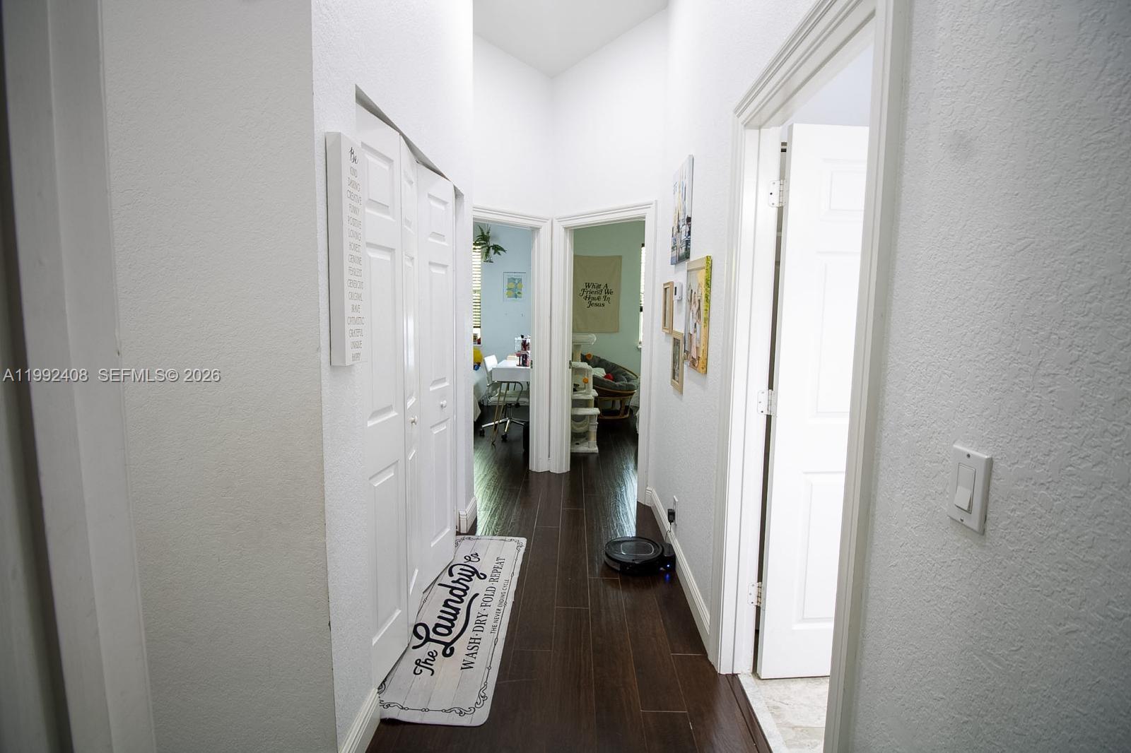 2607 Southwest 99th Way Miramar, FL 33025 - Photo 18 of 50 a view of a hallway with closet and wooden floor