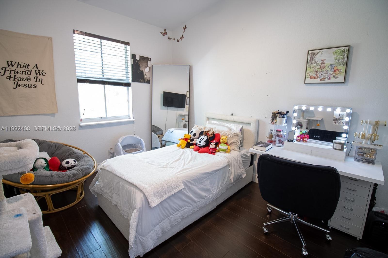 2607 Southwest 99th Way Miramar, FL 33025 - Photo 22 of 50 a bedroom with a bed and a table in it