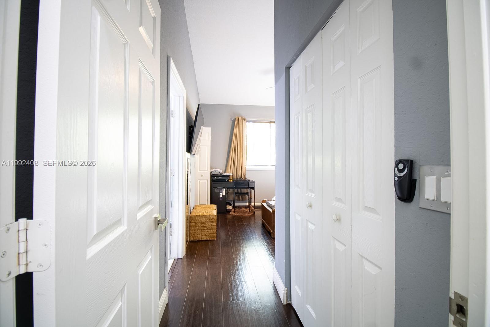 2607 Southwest 99th Way Miramar, FL 33025 - Photo 27 of 50 a view of a hallway with wooden floor and a bathroom