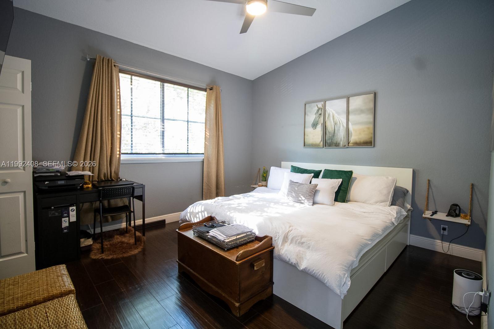 2607 Southwest 99th Way Miramar, FL 33025 - Photo 28 of 50 a bedroom with a bed and a chandelier