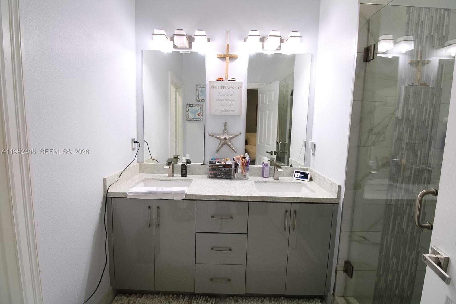 2607 Southwest 99th Way Miramar, FL 33025 - Photo 32 of 50 a bathroom with a double vanity sink mirror and double