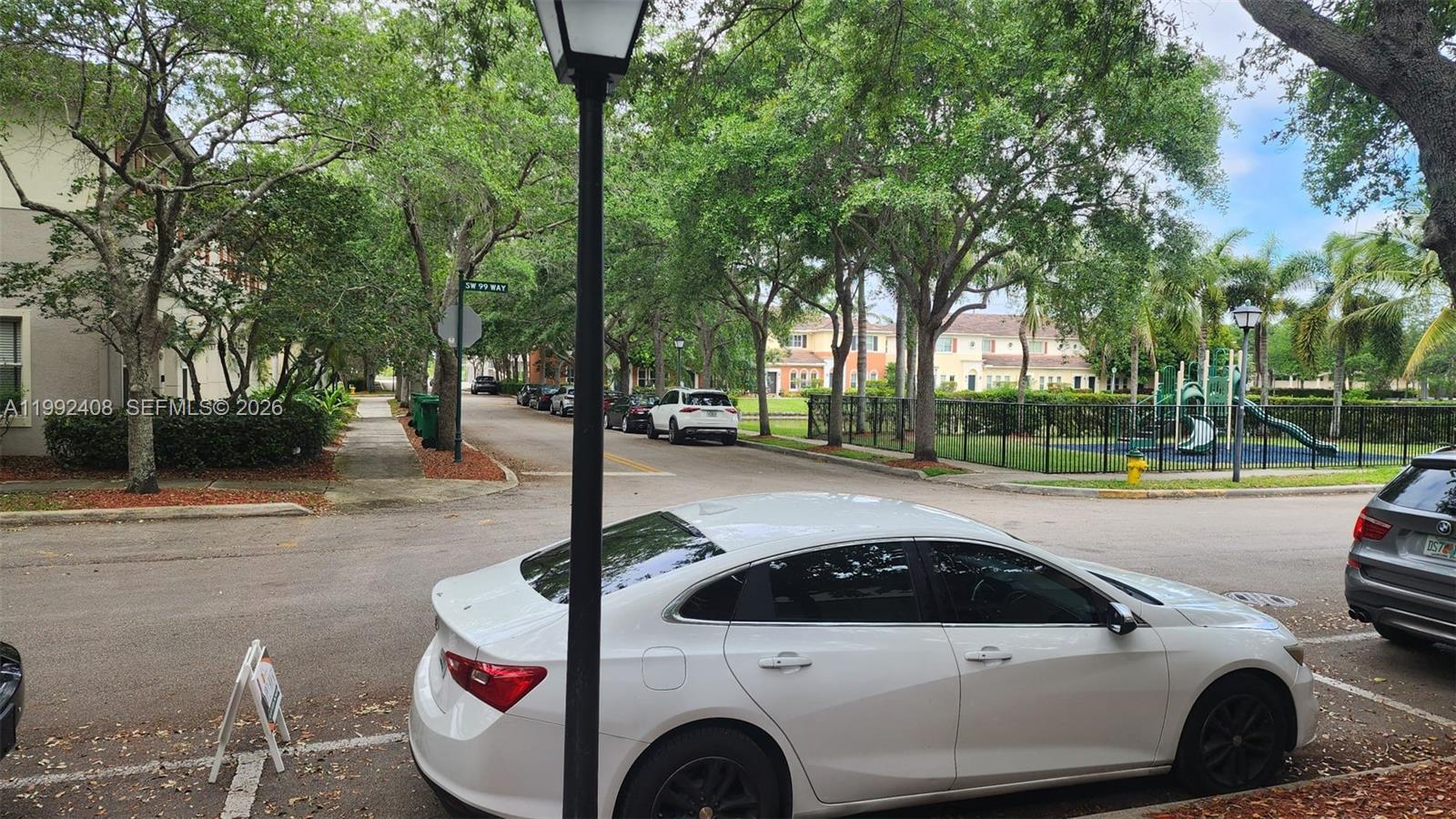 2607 Southwest 99th Way Miramar, FL 33025 - Photo 38 of 50 a view of a street with a cars park side of the road