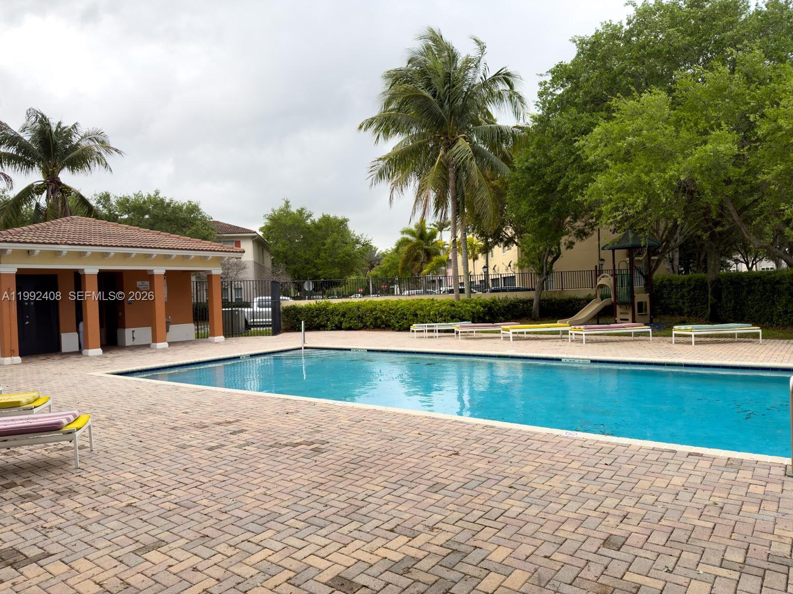 2607 Southwest 99th Way Miramar, FL 33025 - Photo 50 of 50 a view of swimming pool with outdoor seating and house in the background