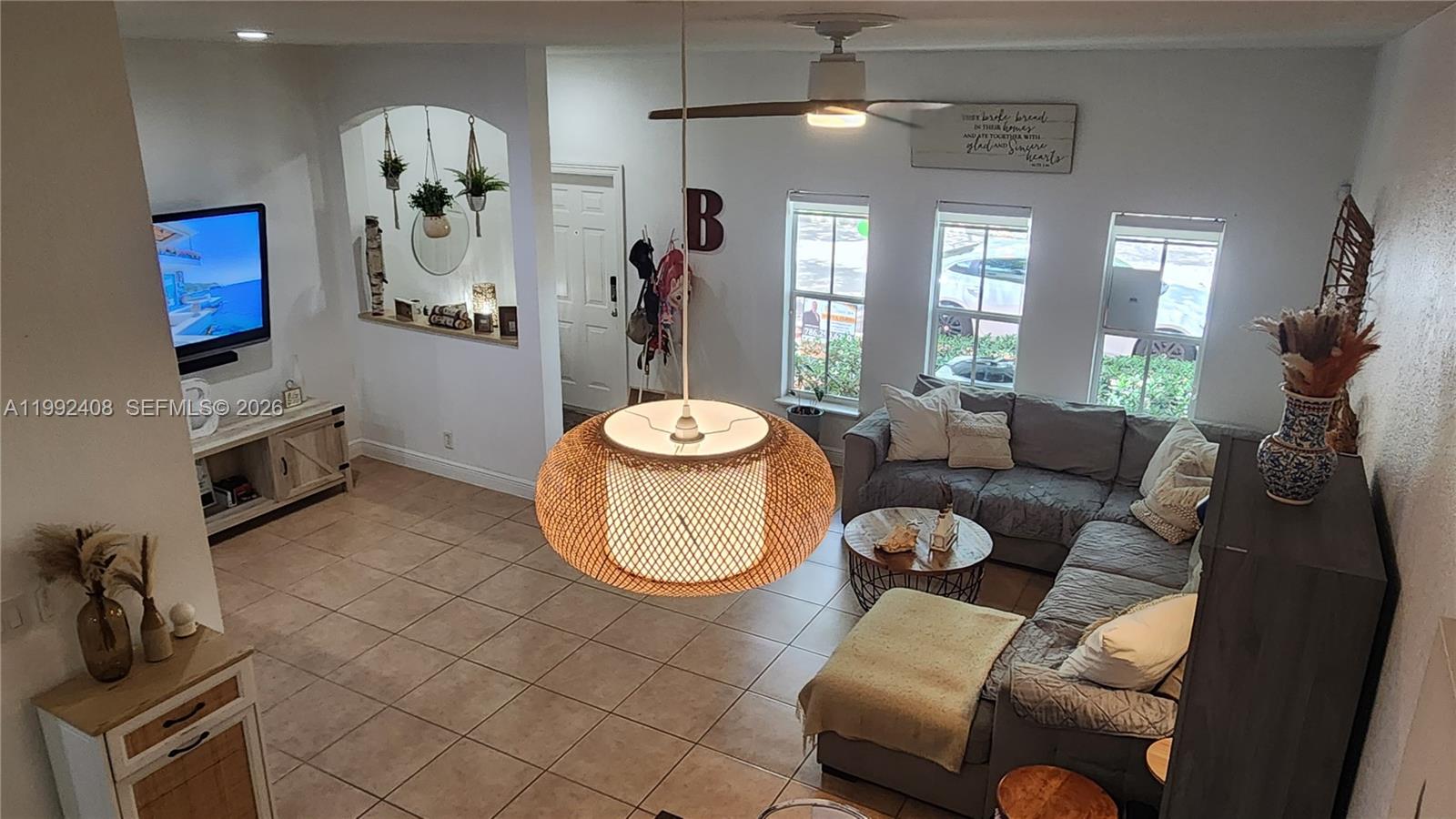 2607 Southwest 99th Way Miramar, FL 33025 - Photo 6 of 50 a living room with furniture and a flat screen tv