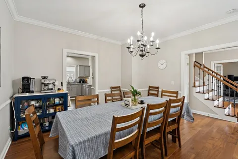 a view of a dining room with furniture and chandelier