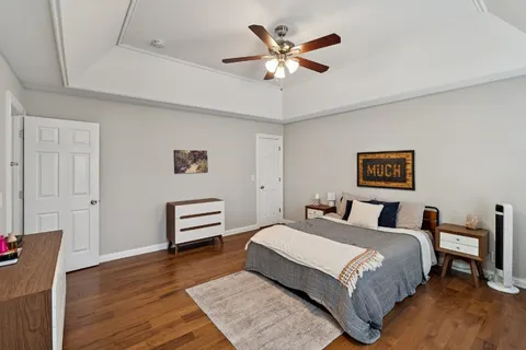 a bedroom with a bed and a chandelier