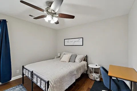 a bedroom with a bed a table and chair