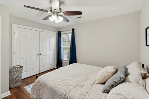 a bedroom with a bed and a chandelier
