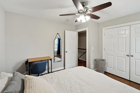 a bedroom with a bed and a chandelier