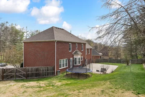 a view of a house with a yard and sitting area