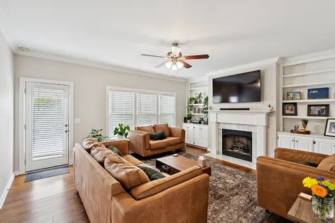 a living room with furniture a flat screen tv and a fireplace