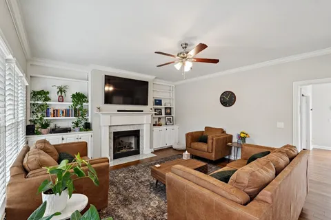 a living room with furniture a fireplace and a flat screen tv