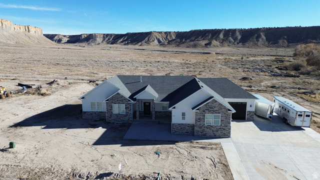 2350 North 1075 West Helper, UT 84526 - Photo 46 of 49 View of front of house with stone siding, concrete driveway, and an attached garage