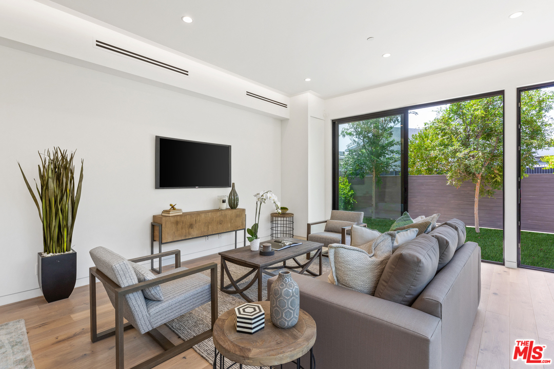 1620 Electric Avenue Venice, CA 90291 - Photo 13 of 31 a living room with furniture a flat screen tv and a floor to ceiling window