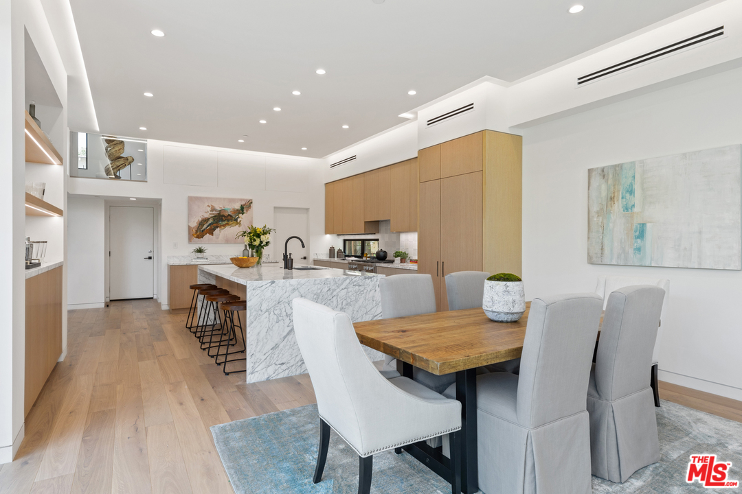 1620 Electric Avenue Venice, CA 90291 - Photo 14 of 31 a kitchen with granite countertop kitchen island stainless steel appliances a dining table and chairs