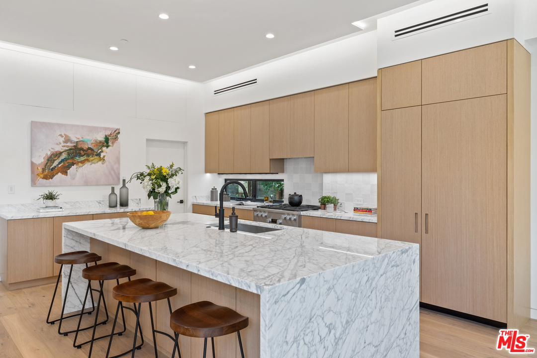 1620 Electric Avenue Venice, CA 90291 - Photo 4 of 31 a kitchen with granite countertop a table chairs stove and cabinets